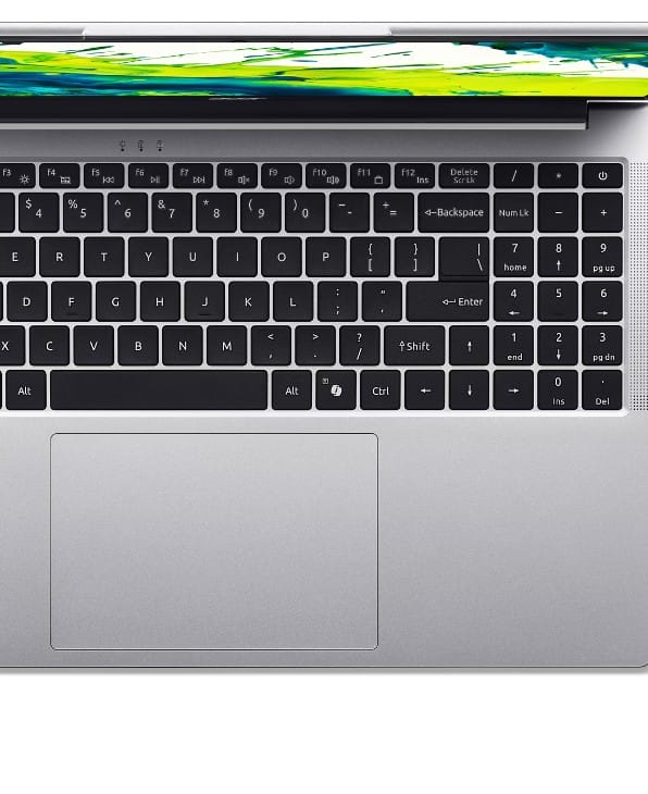 Top-down view of a silver laptop showing a black keyboard and a large touchpad, with a colorful display edge at the top.