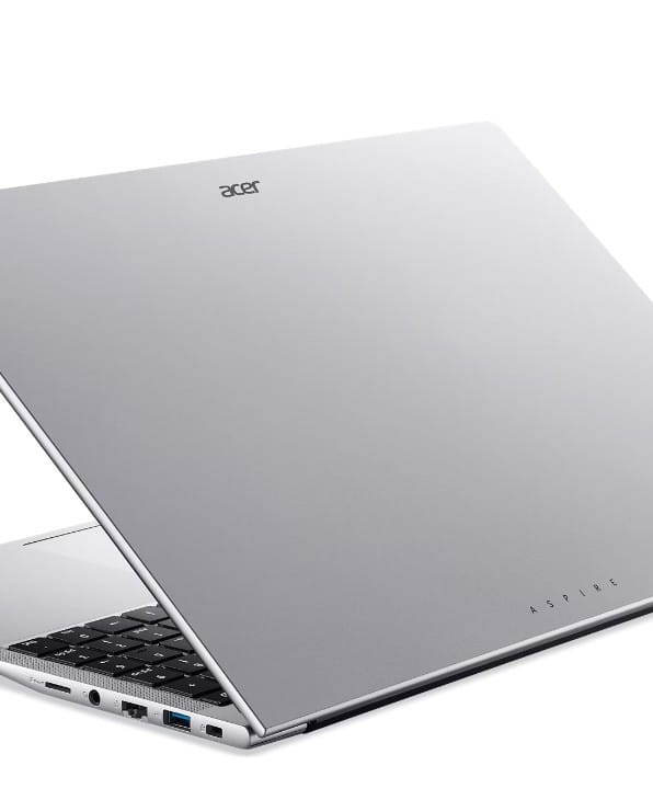 Silver Acer Aspire laptop angled open, showing keyboard and slim profile with ports along the side.