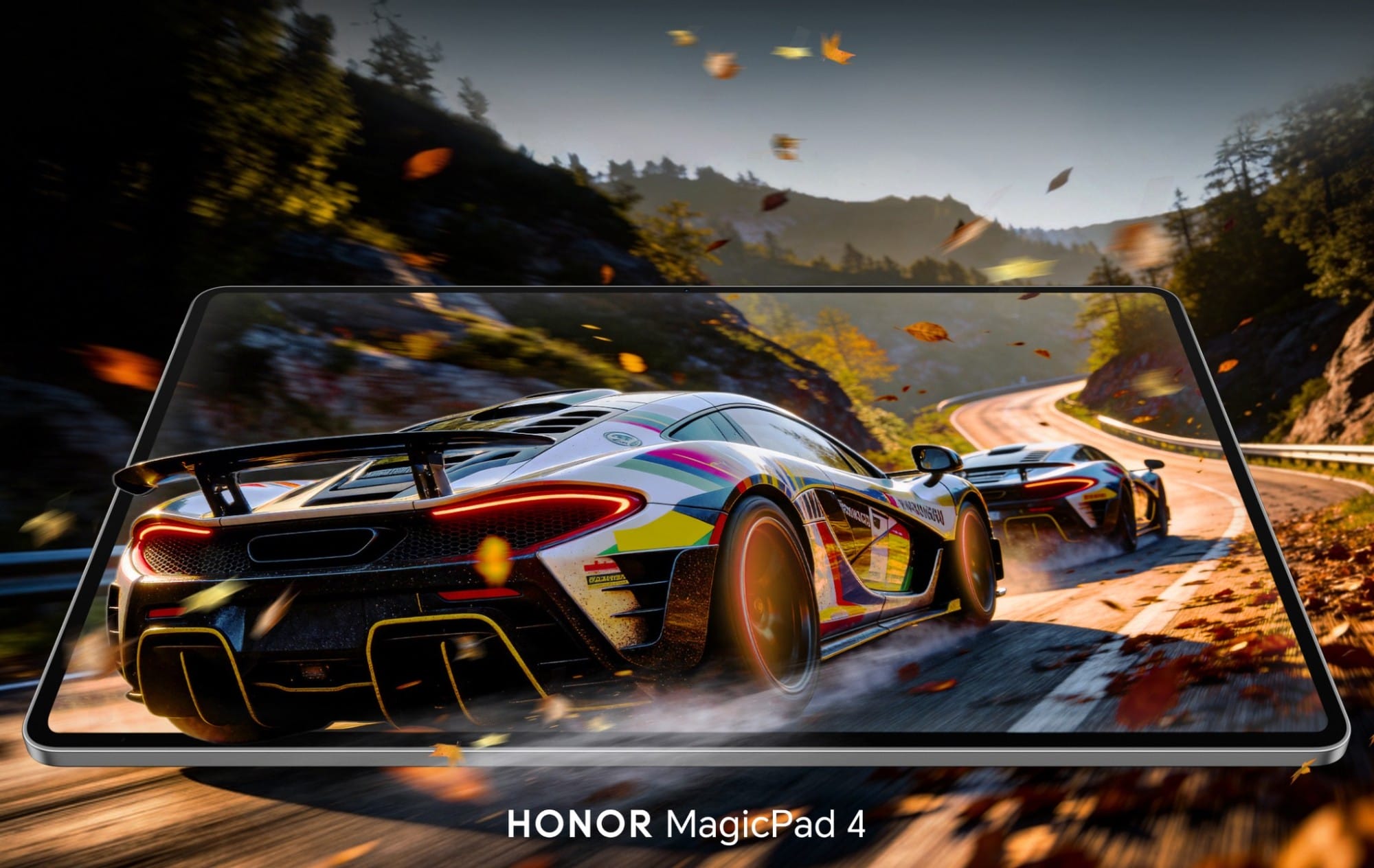 Comic Con Race car on a winding mountain road displayed inside a tablet frame, promoting HONOR MagicPad 4.
