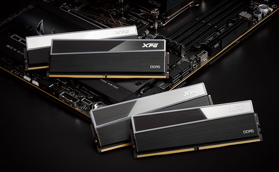DDR5 memory modules from XPG arranged on a motherboard, showcasing black heatspreaders with silver accents