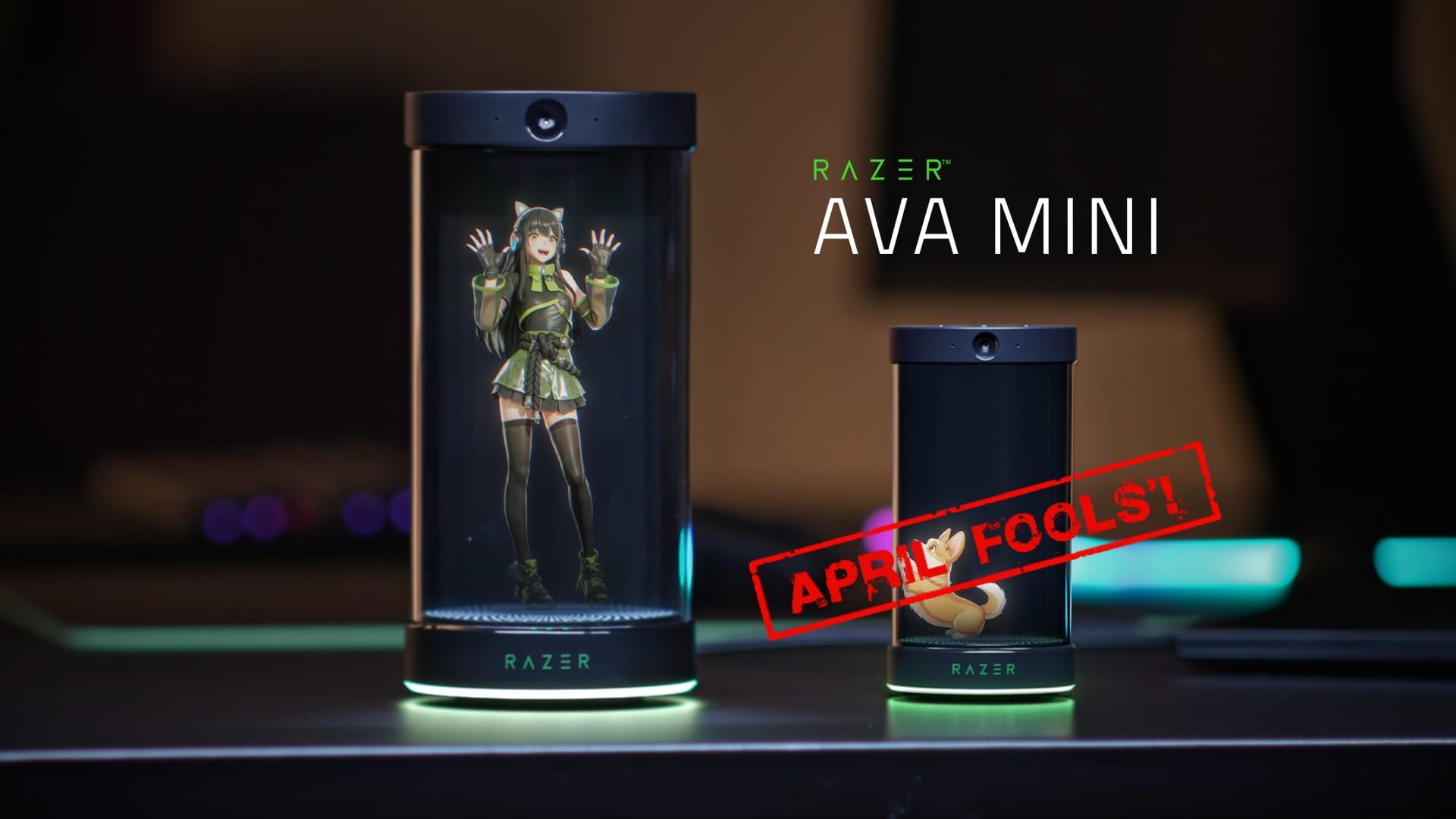 Two Razer Ava Mini display capsules with anime figures, left tall with a green glow and cat-eared character, right small; red'APRIL FOOLS' stamp across.