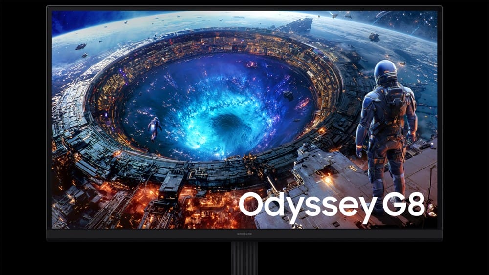 Samsung Odyssey G8 gaming monitor on a stand displaying a sci-fi space scene with a glowing blue wormhole and an astronaut above the edge of a station Start scene.